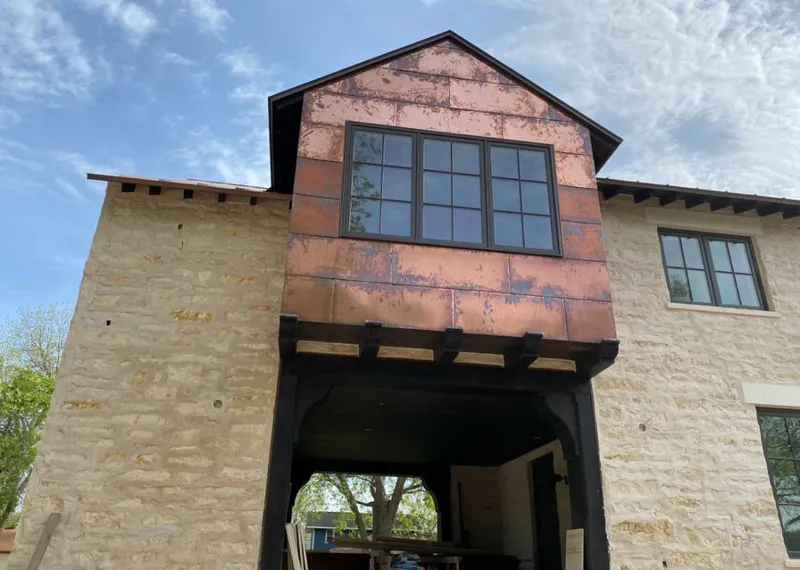 Copper metal panel facade on a stone building for Skylight Installation in Blacklick Estates