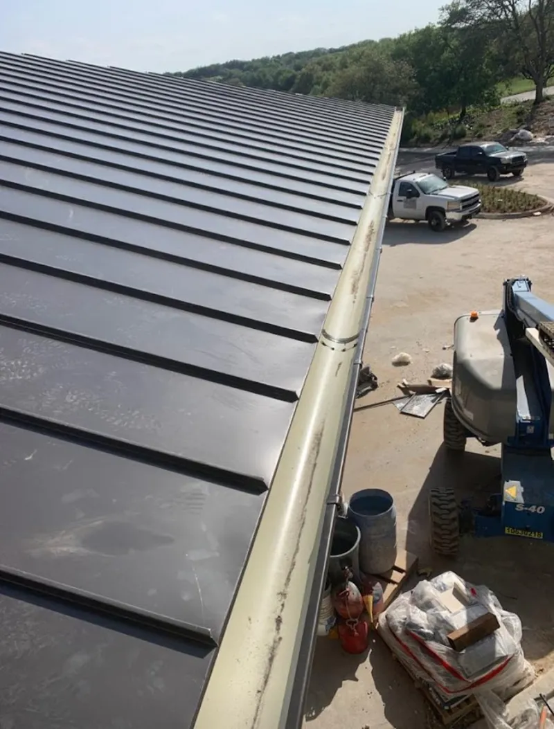 Standing seam panel and gutter detail on a metal roofing jobsite in Blacklick Estates